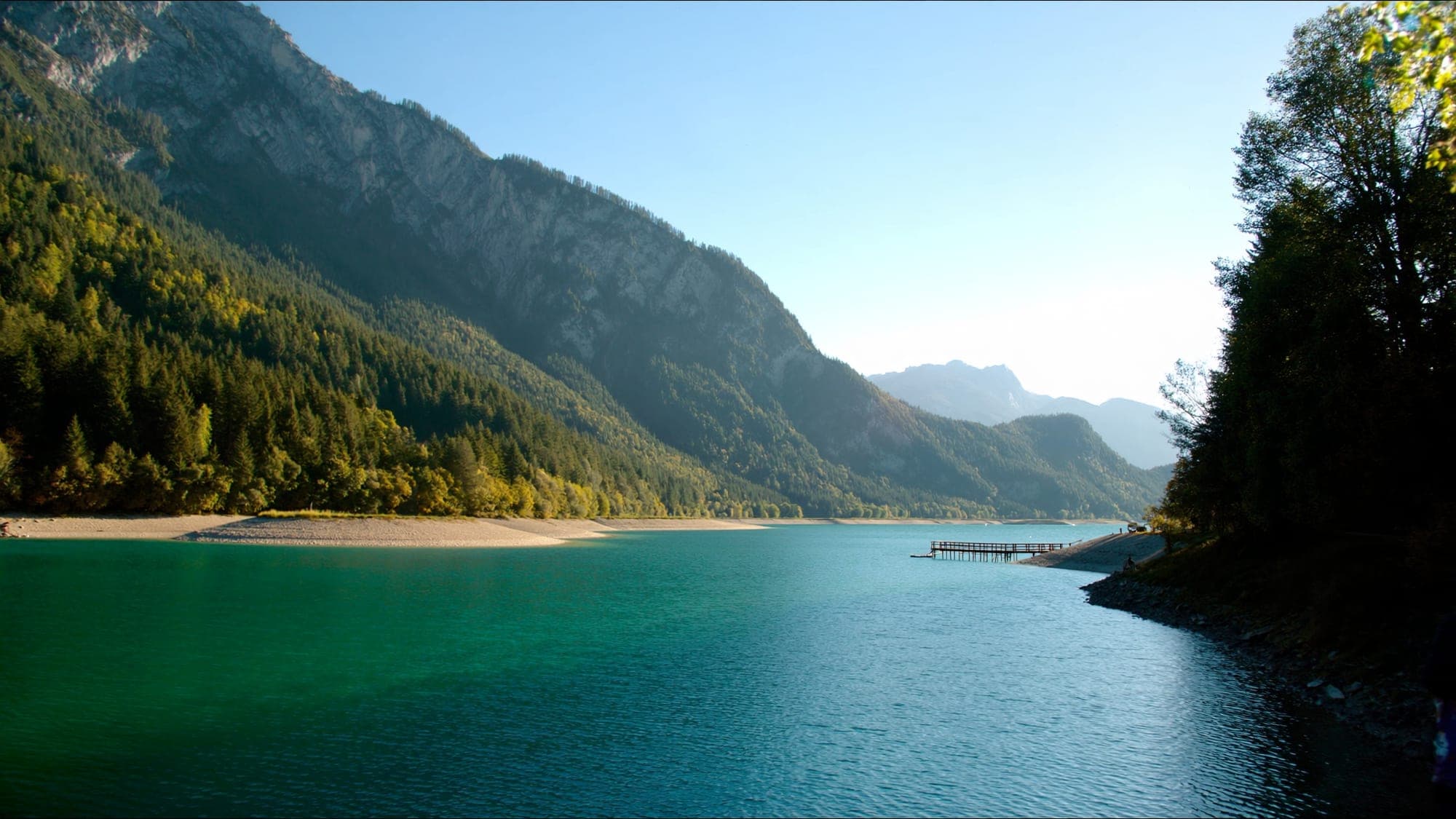 Turquoise Achensee near Pertisau on a summer morning with mountains behind