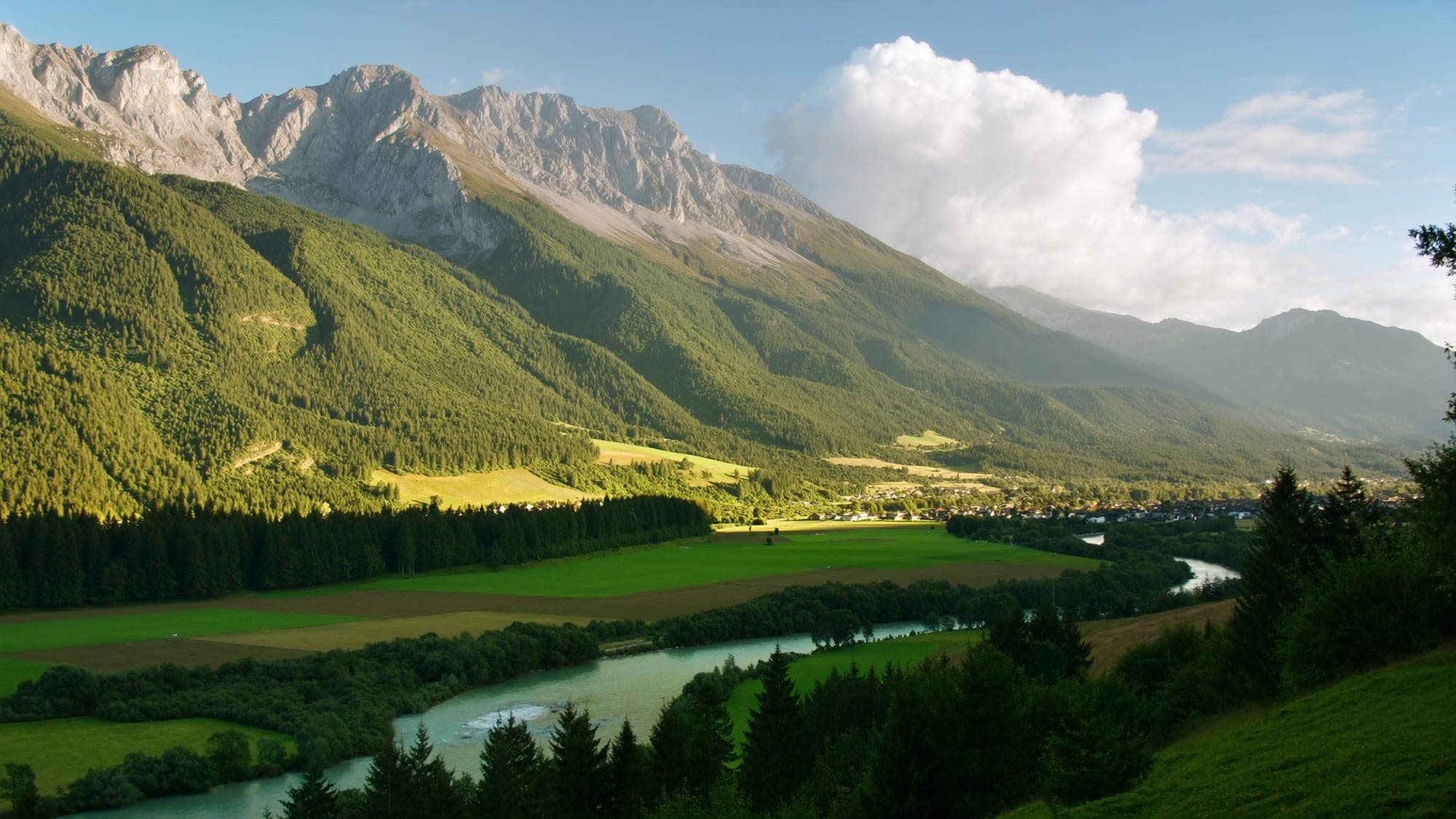 The Inn valley near Rattenberg in late afternoon light with river and mountains