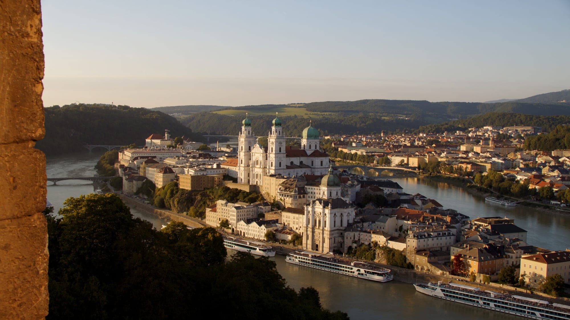 Passau's old town on the peninsula where the Danube, Inn and Ilz meet, with river cruise ships moored along the quay at dusk